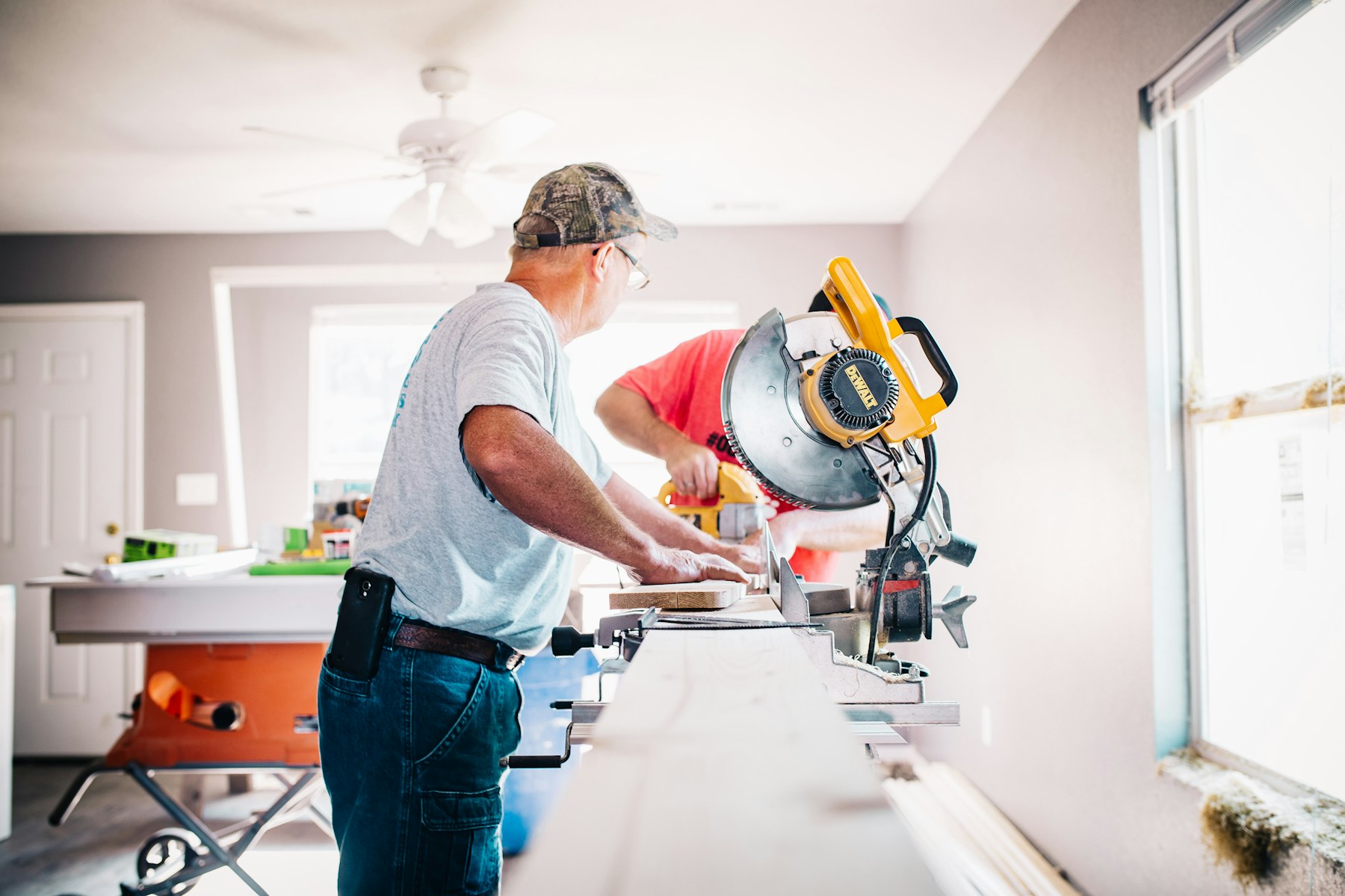 Remodeling contractors cutting and installing finish materials inside a property