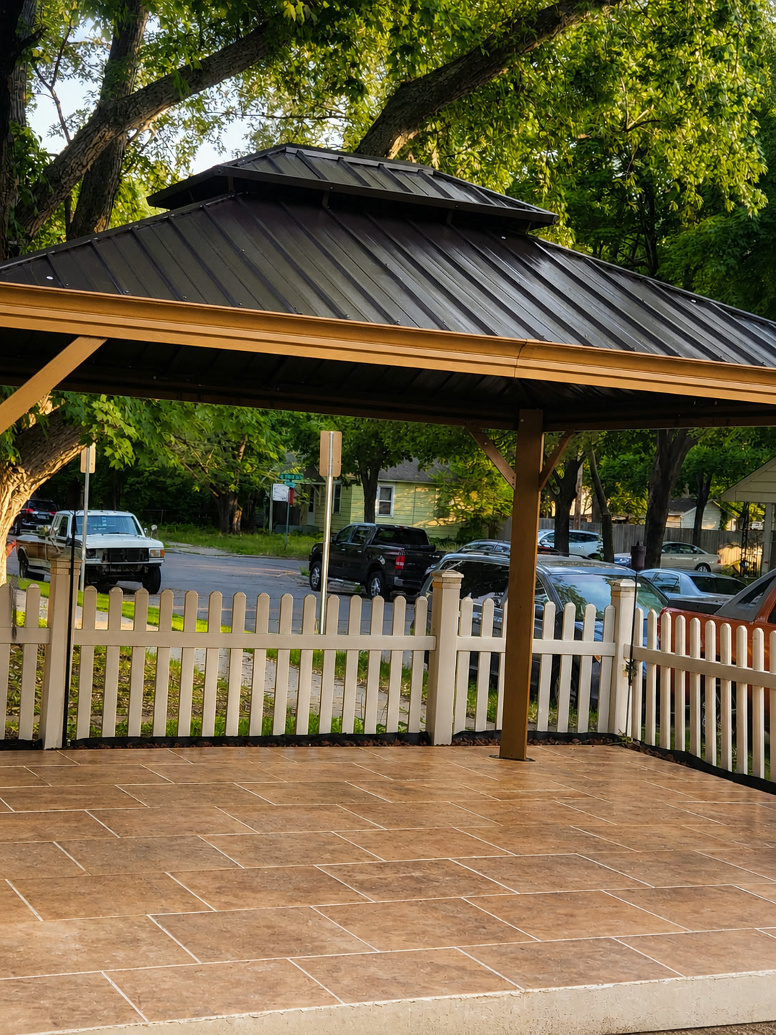 Tom Builders covered patio and deck installation with a metal roof and finished outdoor surface