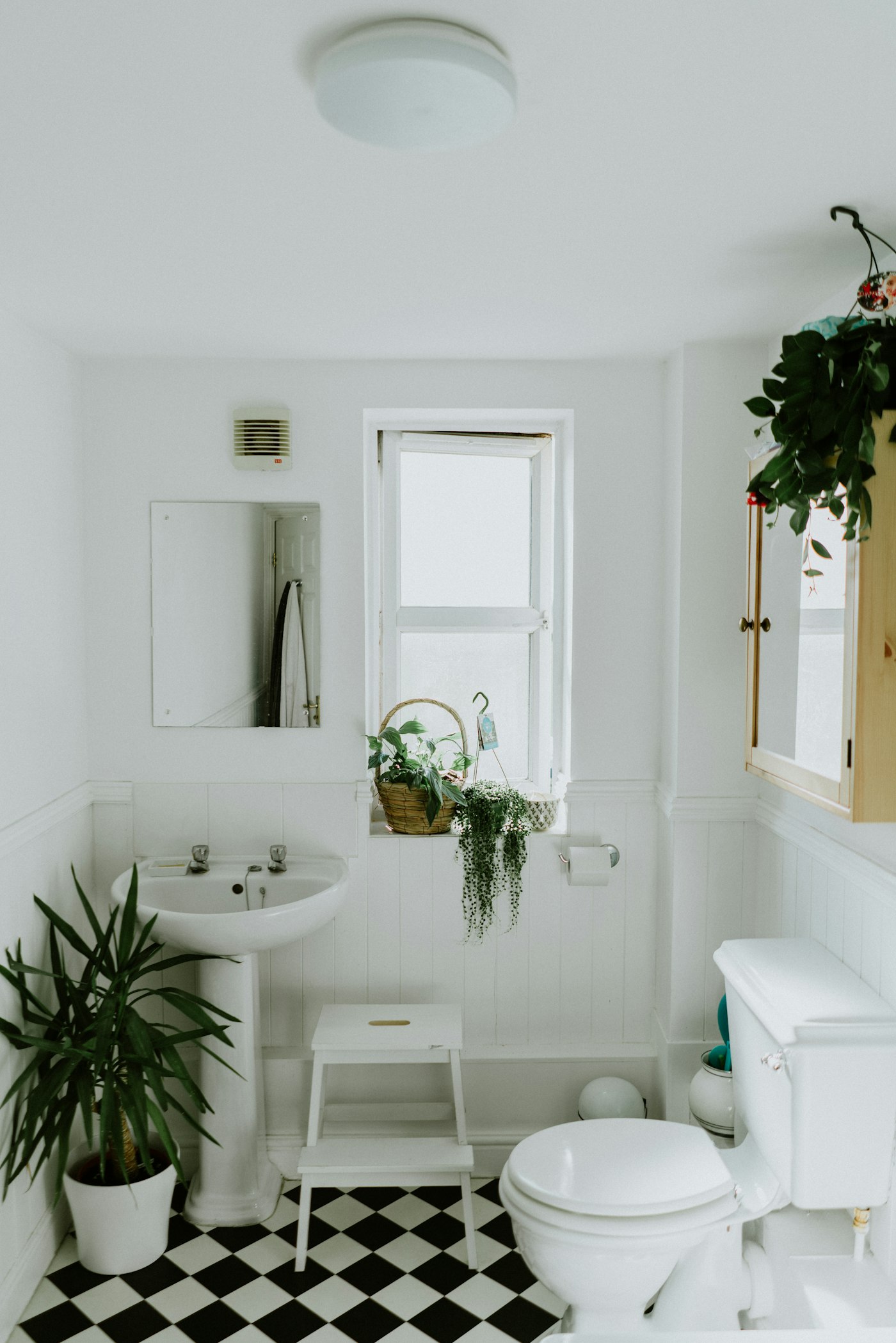 Updated bathroom with a modern vanity, fixtures, tile, and lighting